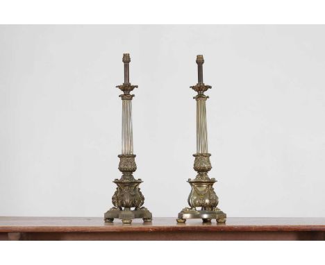 A pair of Regency-style bronze table lamps, early 20th century, each of neoclassical column form with cast folio detail, paw 