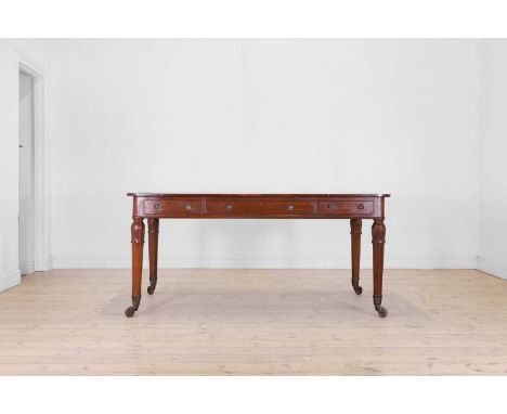 A George IV mahogany library table, c.1830, the rounded rectangular top with an inset gilt-tooled leather surface, above thre