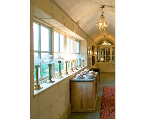A collection of brass lamps by Palmer & Co., 19th century, each of column form with variously cast decoration, each with a gl
