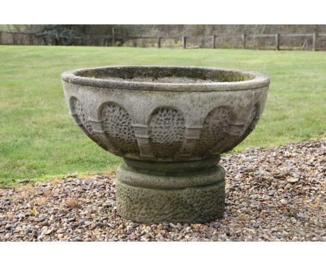 A composition stone planter, 20th century, of round form with an arcaded body, raised on a circular base,80cm diameter 56cm h