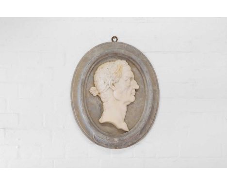 A carved marble portrait relief, late 19th/early 20th century, Italian, centred with a profile head of Julius Caesar crowned 