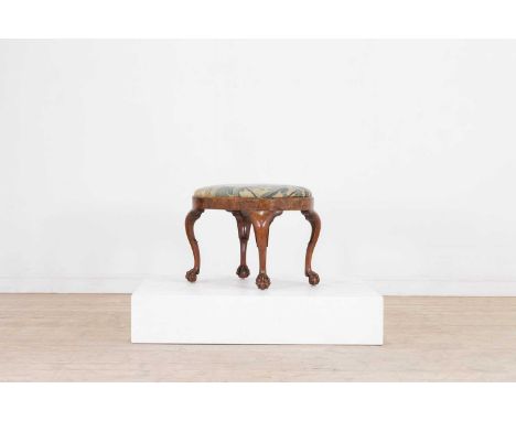 A George II walnut stool, c.1730, with an oval tapestry seat above a plain frieze, and raised on cabriole supports terminatin
