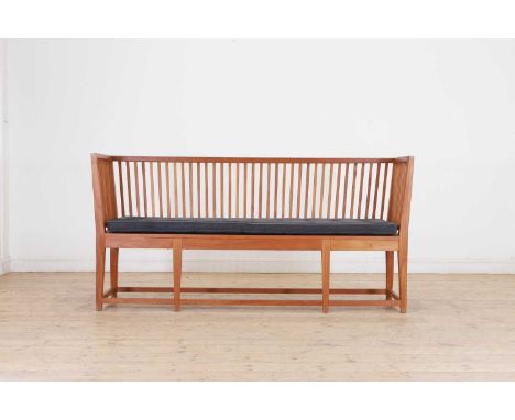 A teak bench in the George III taste, of recent manufacture, with a high back and sides with slatted detail, raised on taperi