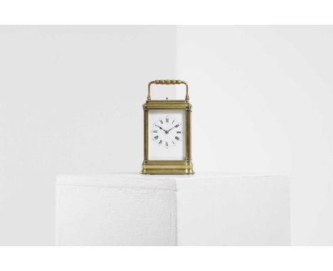 A brass carriage clock,  early 20th century, with an enamel face, the repeating movement striking the hours and half hours on