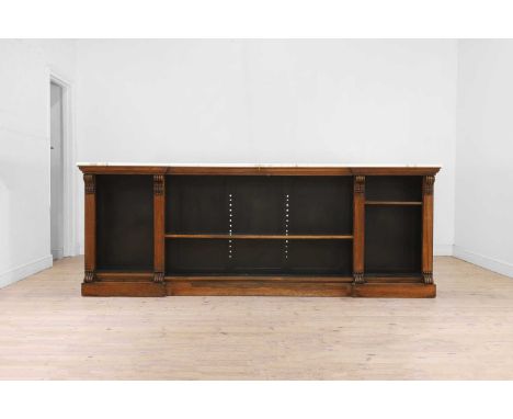 A William IV rosewood low library bookcase, c.1830, of inverted breakfront outline with a later sectional marble top, above o