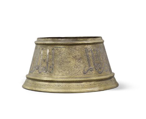 A Mamluk silver-inlaid brass candlestick base Egypt or Syria, 14th Centuryof truncated conical form with flaring foot, a rais
