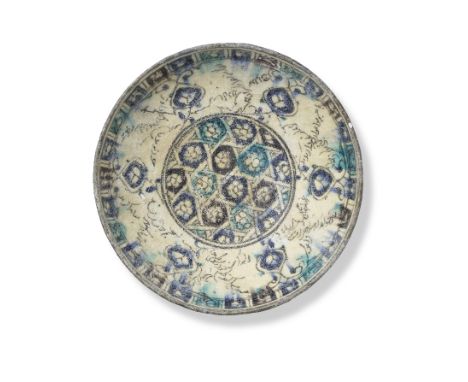 A Kashan underglaze-painted pottery bowl Persia, 13th Centuryof rounded form on a short foot, decorated in cobalt blue, turqu