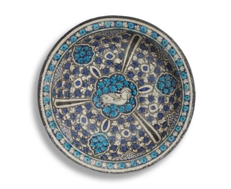 A large Sultanabad pottery dish Persia, 14th Centuryof shallow rounded form with everted rim on a short foot, decorated in co