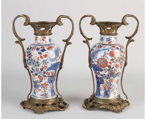 Two Imari porcelain vases with bronze mounts. 19th century. One vase edge glued. Dimensions: H 20 cm. In fair/good condition.