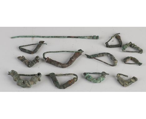 Lot of 12 bronze Persian artefacts from Luristan. 500 - 1000 BC. Among other things; 11x fibulae + 1x pin. Dimensions: 3 - 12