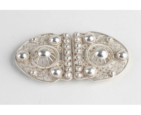 Silver buckle, 833/000, contoured model with filigree and buttons. 10x5cm. about 35.3 grams. Small piece of a button is missi