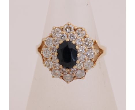 Elegant yellow gold ring, 585/000, with diamond and sapphire. Ring with a large double rosette, set in the middle with an ova