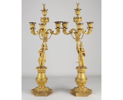 Two fire-gilt Charles Dix bronze candlesticks with oriental figures. Circa 1830. Matching Charles Dix mantel clock is also of
