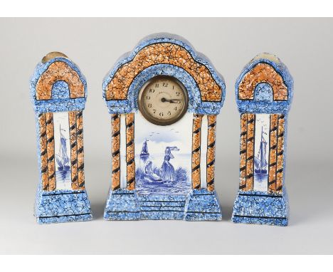 Three-piece antique ceramic clock set with Dutch motifs. Monogram. Circa 1910. Back top edge of vase damaged, otherwise good.