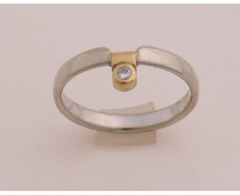White gold ring, 585/000, with diamond. Sleek convex ring with a yellow gold element set with a brilliant cut diamond. Brand 