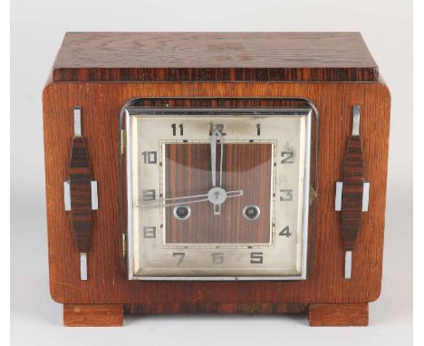 Art Deco mantel clock made of coromandel wood. Striking mechanism on three gong spirals. Circa 1930. Dimensions: 23 x 30 x 15