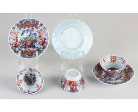 Three Chinese Imari porcelain cups and saucers. 18th century. Garden/gold decor. Contoured border. All cups glued, saucers go