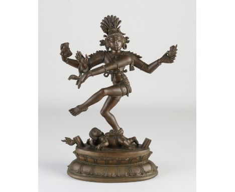 Ancient Indian dancing Buddha of bronze, with four arms, standing on child with serpent and lotus flower. Dimensions: H 33 cm