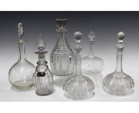 A pair of cut glass globe and shaft decanters with stoppers and four others and one Hollands decanter label (7) 