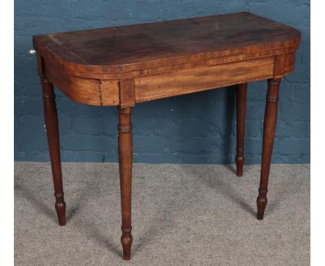 A Victorian mahogany fold over card table.  