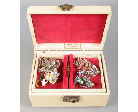 A vintage Thoren's musical jewellery boxes with contents of various brooches.  