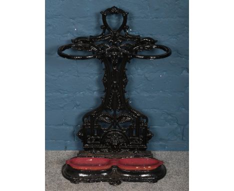 An ornate black painted metal stick stand.  