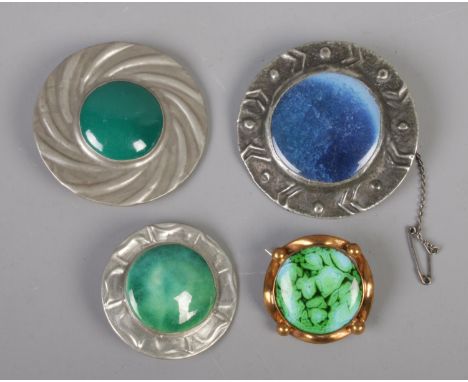 Four brooches. Includes three Ruskin style examples and a yellow metal enamel example.  