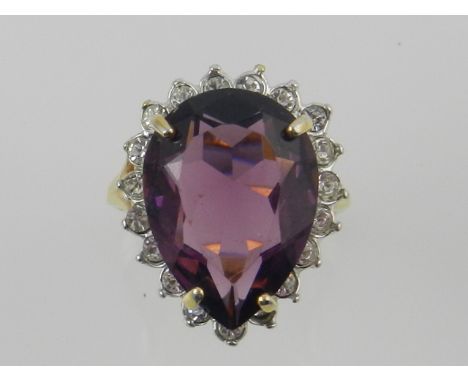 A yellow metal diamond and amethyst set dress ring, the shank stamped 18K 