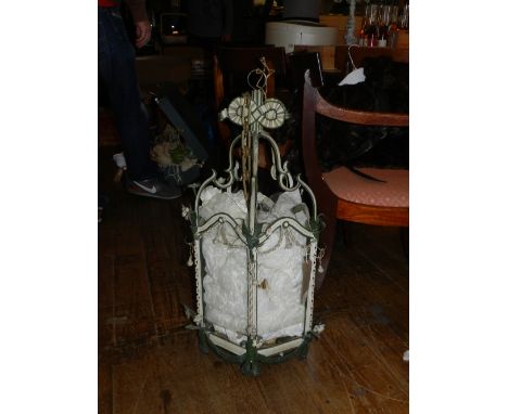 An early 20th century cream and green painted hexagonal ceiling lantern, decorated with flowers. H.83cm 
