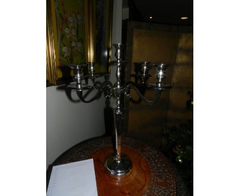 A pair of silver plated five light four branch candelabra.