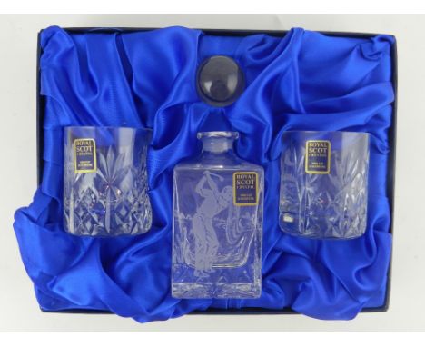 A cased Royal Scot crystal decanter, together with a cased set of two glasses, each engraved with images of golfers. 