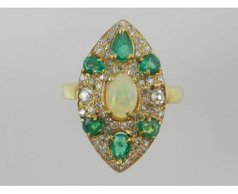 An unusual yellow metal, diamond, emerald, and opal set dress ring of marquis form. 