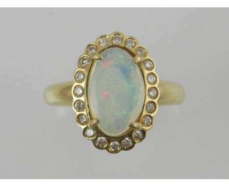 A yellow metal, opal, and diamond set dress ring, the shank stamped 750. 