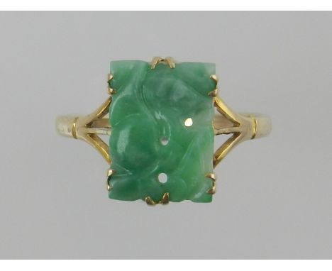 A yellow metal and pierced jade ring, the shank stamped 9ct.