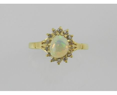 A yellow metal, opal, and diamond cluster ring.