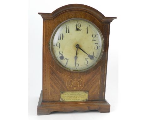 An Edwardian oak and mahogany cased mantel clock, having an Arabic dial, singed William L. Gilbert Clock Co., USA, the archit