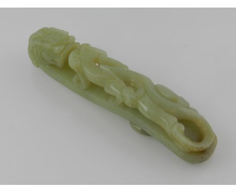 A carved Chinese jade belt buckle, in the form of a dragon L.12cm