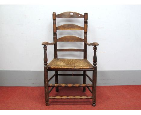 A XIX Century Ash and Elm Ladder Back Armchair, with rushed seat on circular legs united by stretchers.