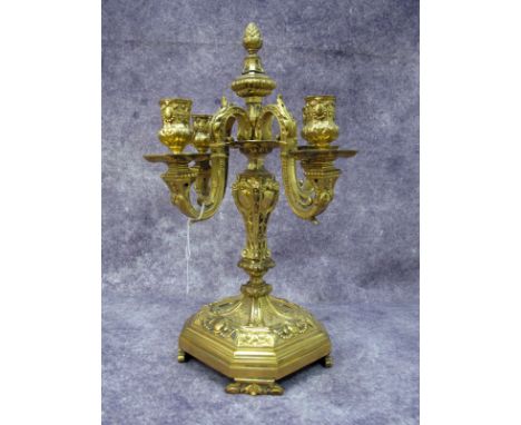 A Late XIX Century Gilt Metal Four Branch Candelabrum, ornately cast with foliage scrolls, swags and scales, surmounted with 