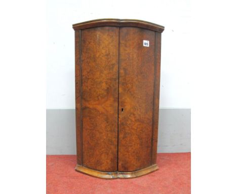 A Burr Walnut Bow Fronted Corner Cupboard, with one internal shelf, 62cm high.