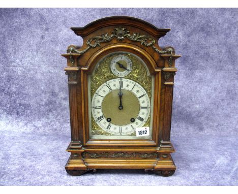 A Late XIX Century German Walnut Cased Bracket Clock, by Lenzkirch, the arched brass dial with silvered chapter ring with Rom