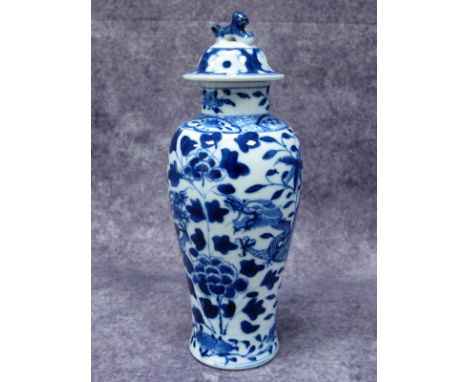 A Late XIX Century Chinese Porcelain Baluster Vase and Cover, with dog of fo finial, painted in blue with dragons amongst flo