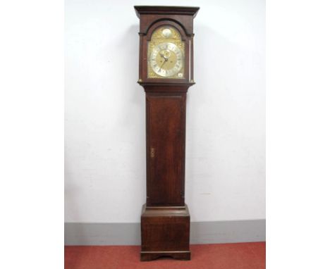 An XVIII Century Oak Longcase Clock, the hood with stepped pediment over arched door with reeded columns, brass dial with sil