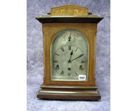 An Edwardian Mahogany Inlaid Chiming Mantel Clock, the silvered dial with Roman numerals with chime/silent dial above, German