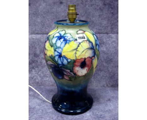 A Moorcroft Pottery Vase, (converted to a lamp) of baluster form, painted in the Orchid pattern against a mottled blue/green 