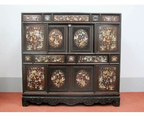 An XVIII Century Chinese Hardwood Cabinet, with four mother of pearl inlaid upper panels depicting soldiers on horseback abov