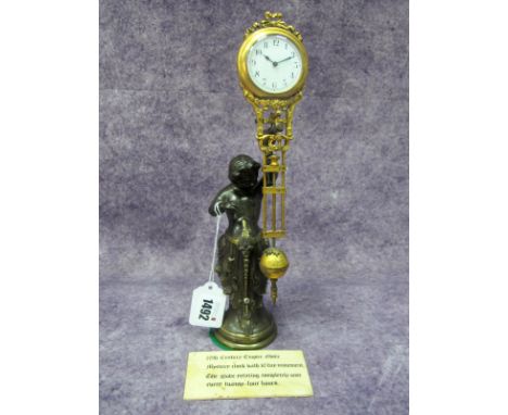 A French Late XIX Century Speltre Mystery Clock, modelled in the form of a scantily clad child holding a club supporting the 