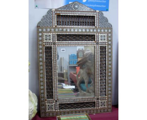 An Anglo-Indian Style Wall Mirror, of architectural form, elaborately inset with ebony, mother of pearl and ivory with geomet