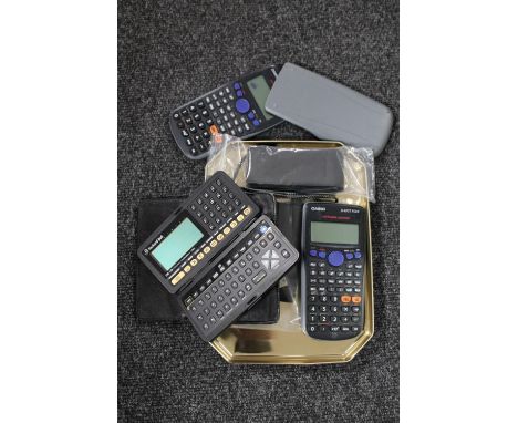 An Olympus dictaphone together with two Casio calculators, Packard Bell personal organiser etc.