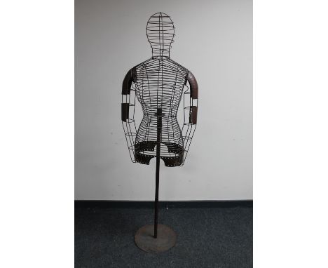 A wire metal female mannequin torso on stand 